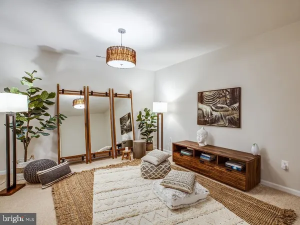 a bedroom with furniture and a potted plant
