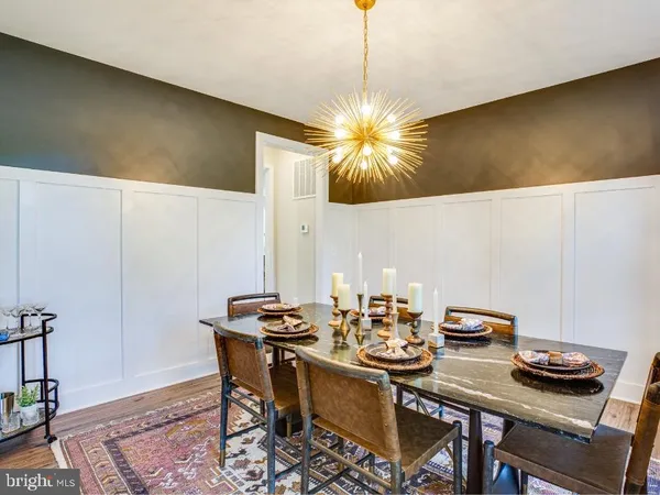 a view of a dining room with furniture and a chandelier fan