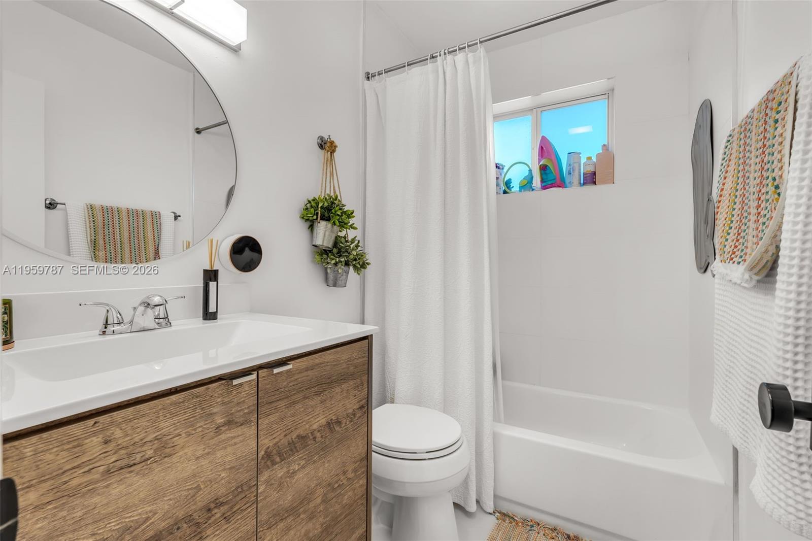 10971 Southwest 177th Street Miami, FL 33157 - Photo 23 of 41 a bathroom with a sink a toilet and shower