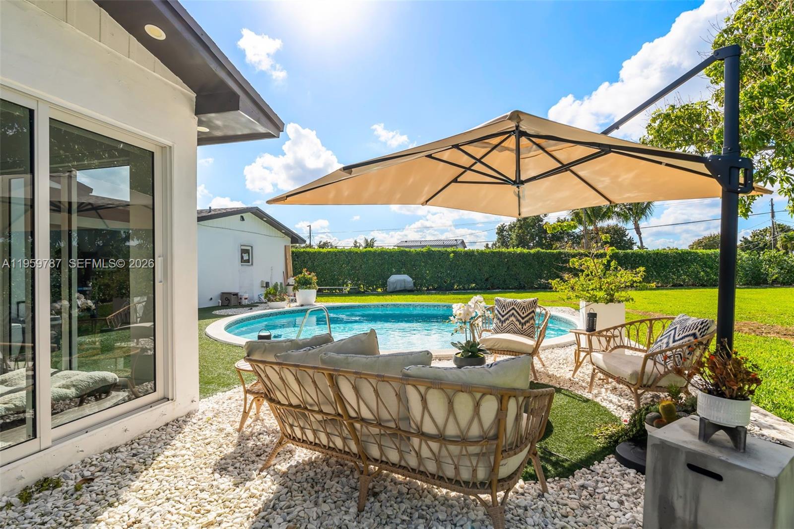 10971 Southwest 177th Street Miami, FL 33157 - Photo 26 of 41 a view of an outdoor sitting area with furniture and garden view