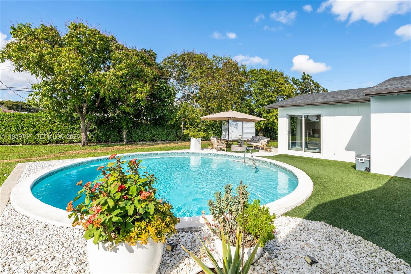 10971 Southwest 177th Street Miami, FL 33157 - Photo 30 of 41 a swimming pool with outdoor seating and yard