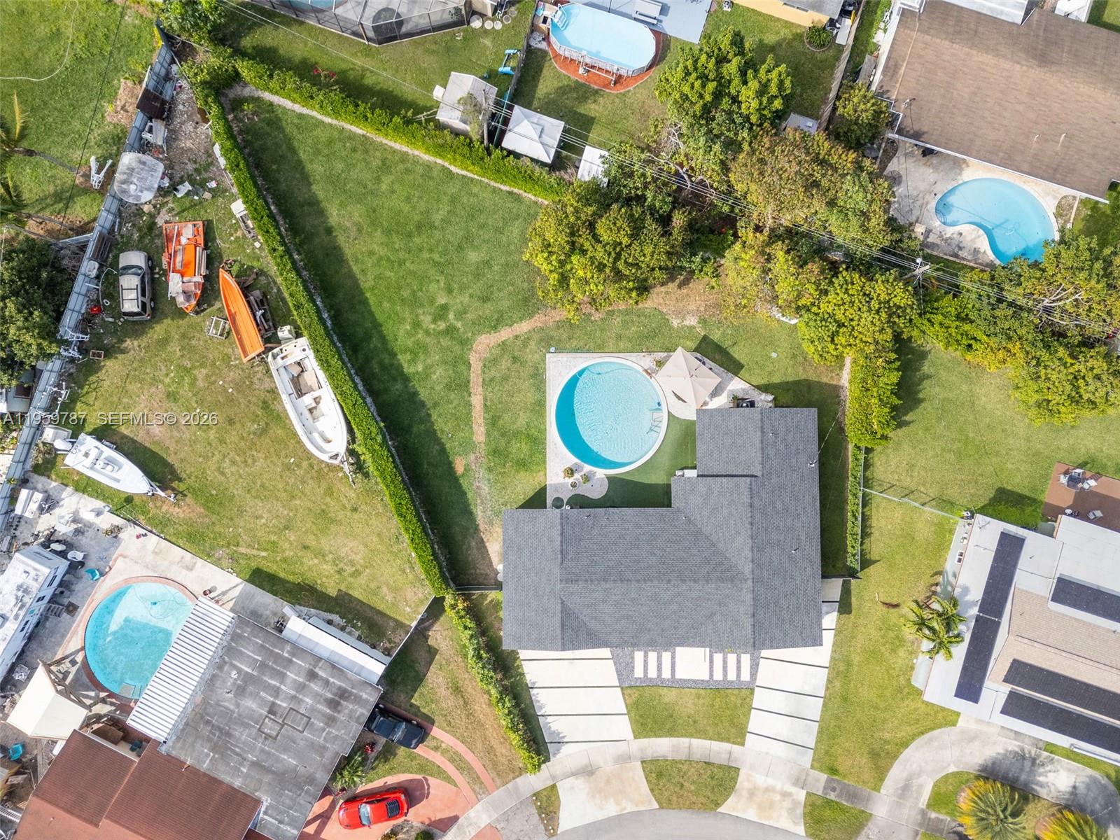 10971 Southwest 177th Street Miami, FL 33157 - Photo 33 of 41 an aerial view of a house with swimming pool and outdoor seating
