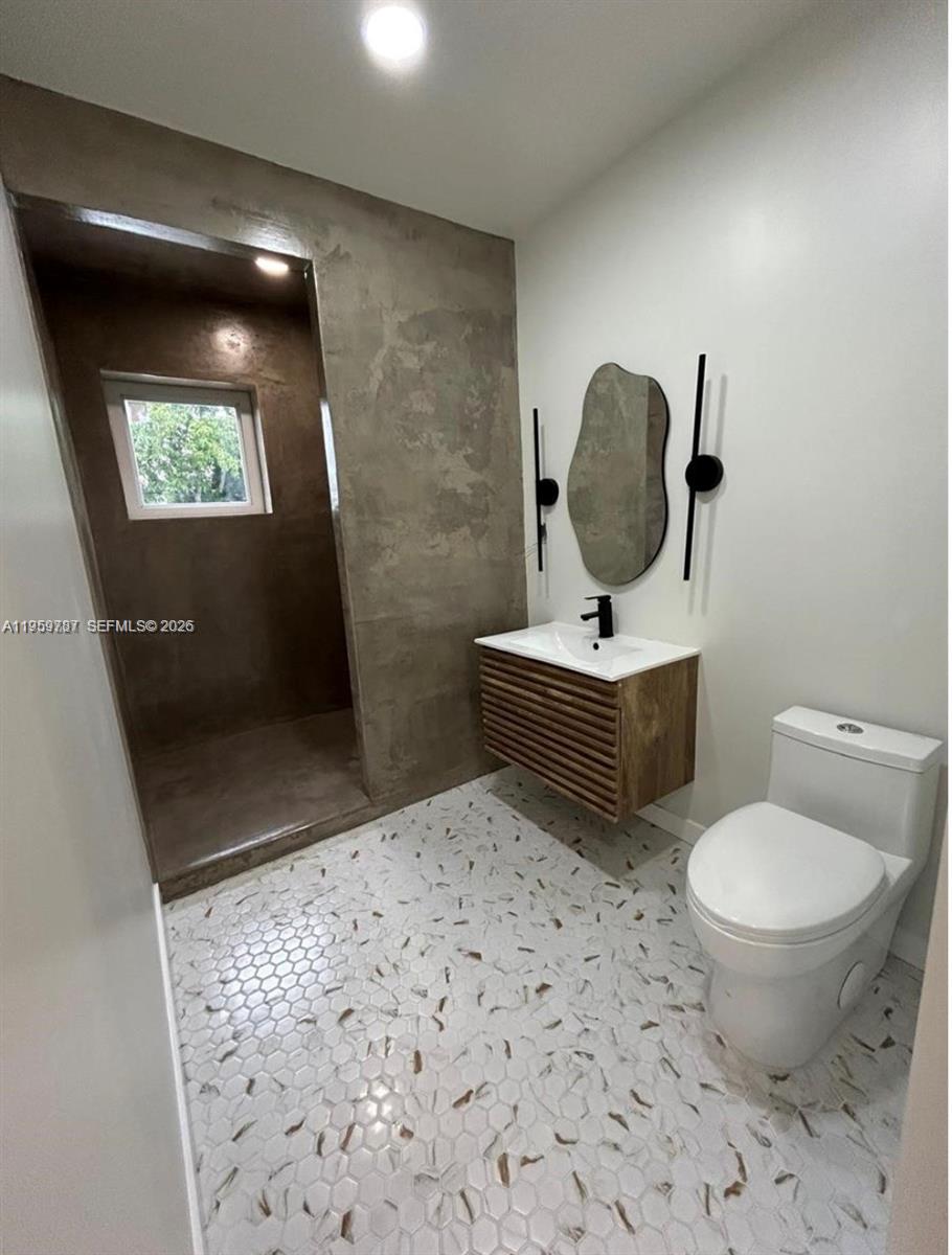10971 Southwest 177th Street Miami, FL 33157 - Photo 39 of 41 a bathroom with a toilet a sink and mirror