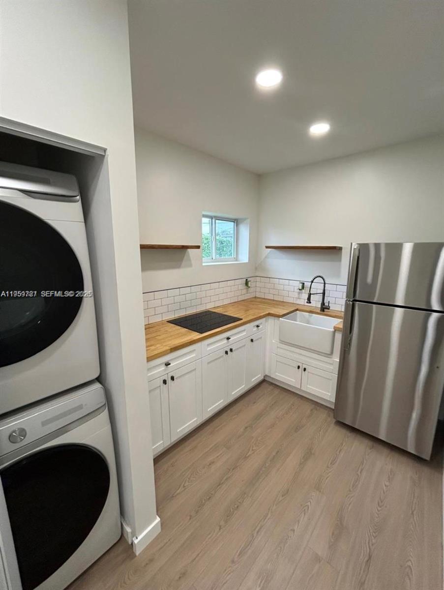 10971 Southwest 177th Street Miami, FL 33157 - Photo 40 of 41 a kitchen with a refrigerator sink and cabinets