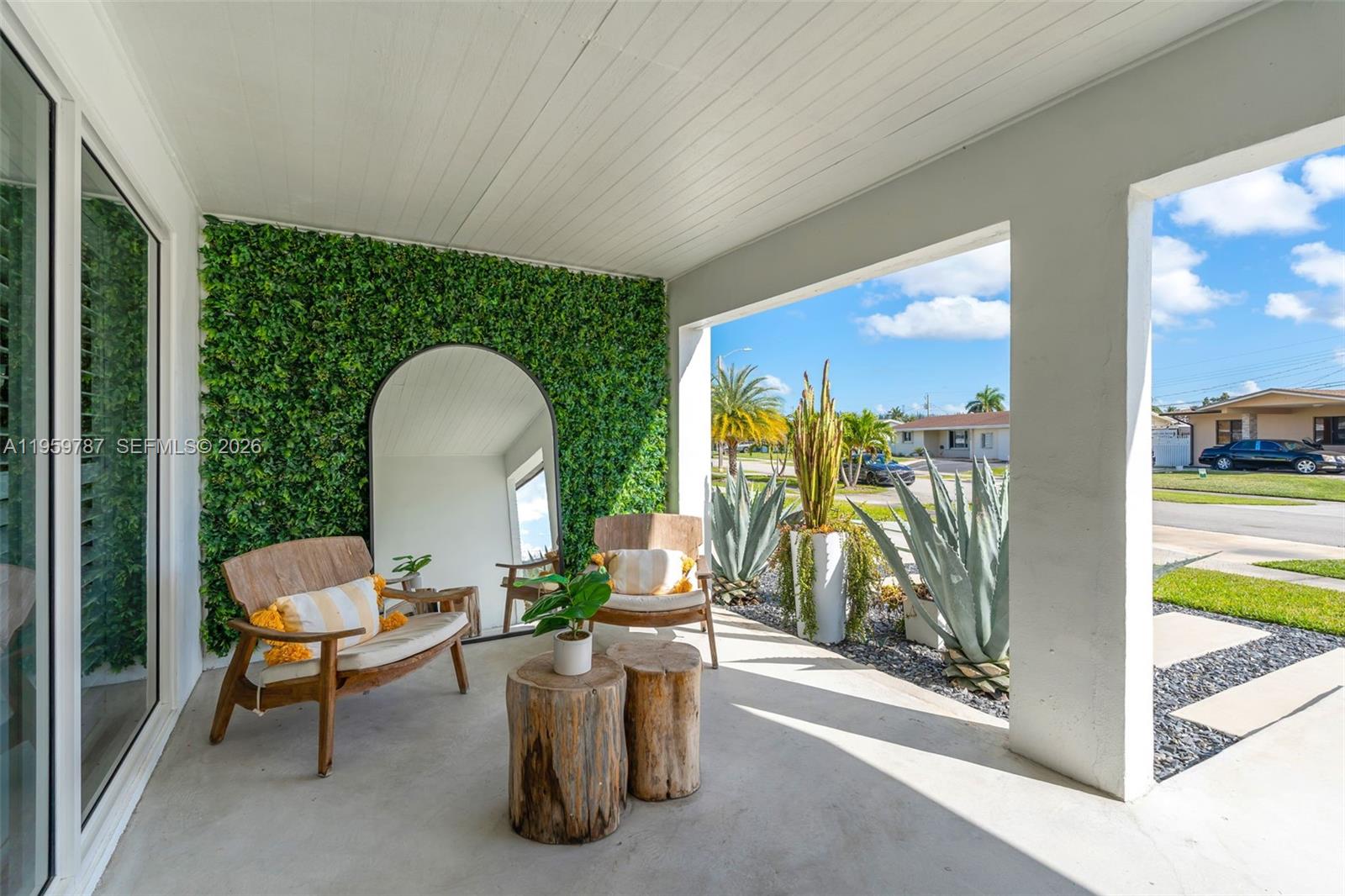 10971 Southwest 177th Street Miami, FL 33157 - Photo 5 of 41 a living room with furniture and a floor to ceiling window