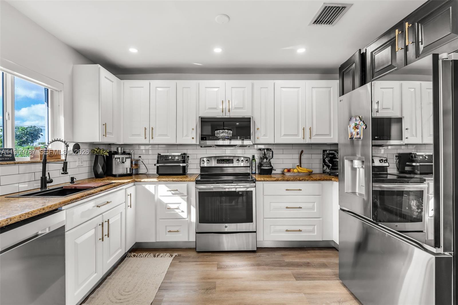10971 Southwest 177th Street Miami, FL 33157 - Photo 7 of 41 a kitchen with stainless steel appliances granite countertop a refrigerator and a stove top oven