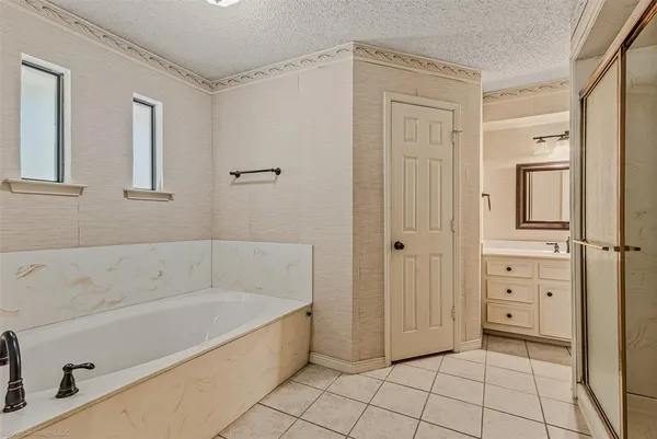 a bathroom with a bathtub and a shower