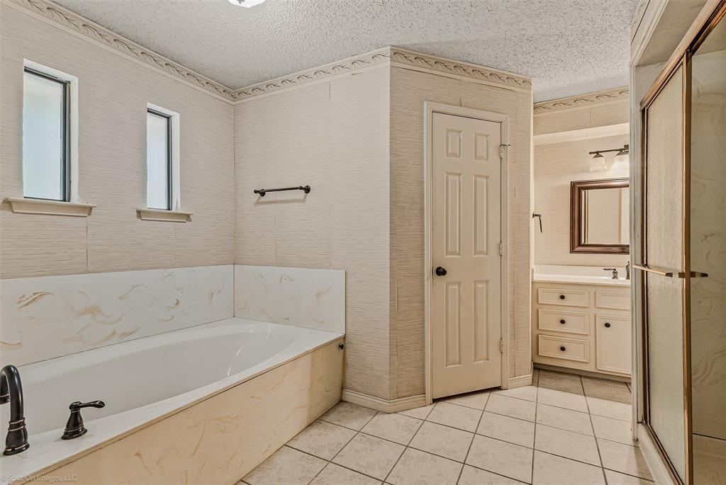 9510 South State Highway Scurry, TX 75158 - Photo 16 of 26 a bathroom with a bathtub and a shower