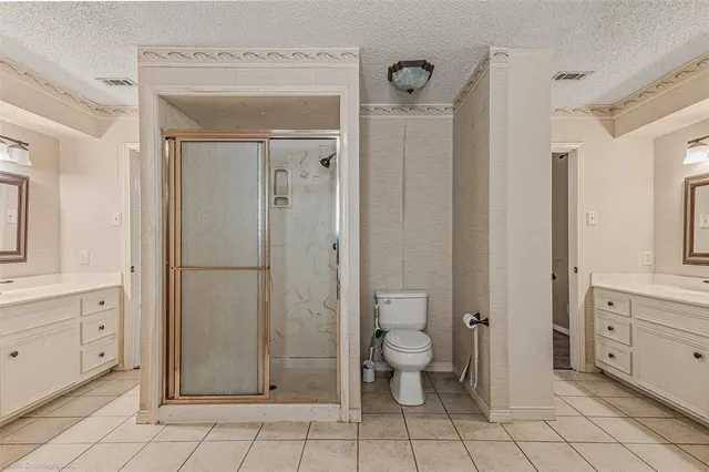 a bathroom with a toilet a sink and shower