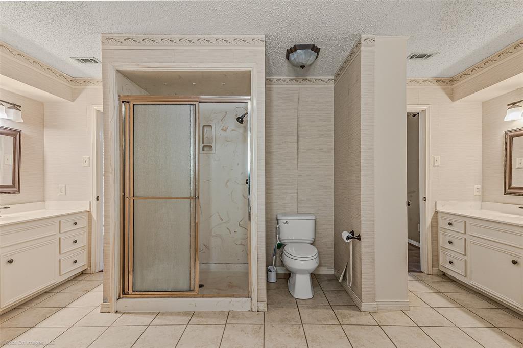 9510 South State Highway Scurry, TX 75158 - Photo 17 of 26 a bathroom with a toilet a sink and shower