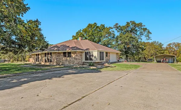 a front view of house with yard and green space