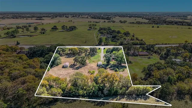 an aerial view of a residential houses with outdoor space