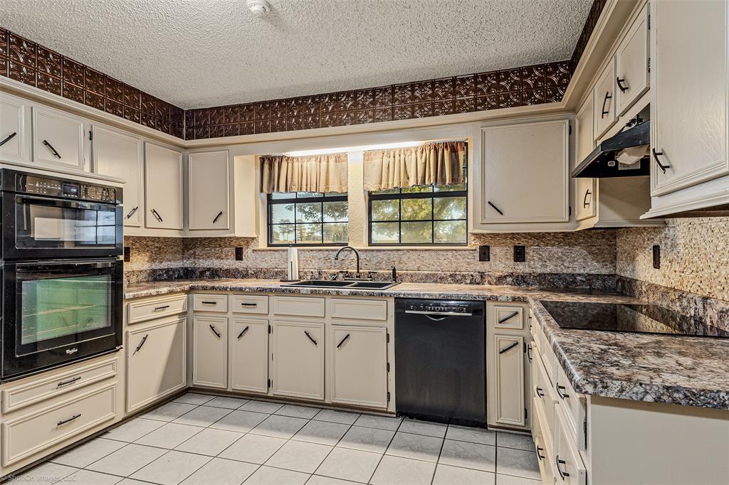 9510 South State Highway Scurry, TX 75158 - Photo 7 of 26 a kitchen with a stove sink and cabinets