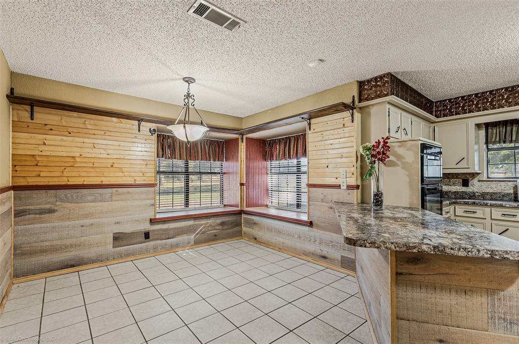 9510 South State Highway Scurry, TX 75158 - Photo 9 of 26 a kitchen with stainless steel appliances granite countertop a sink and a stove