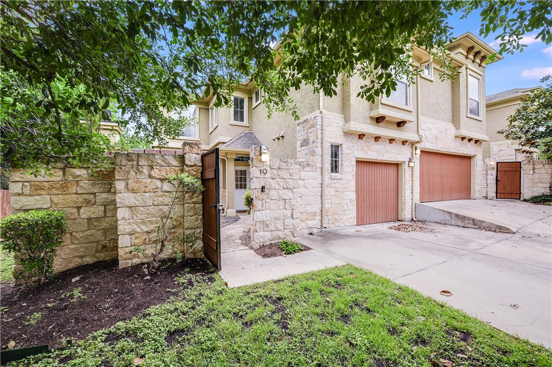 a view of a house with a yard and tree s