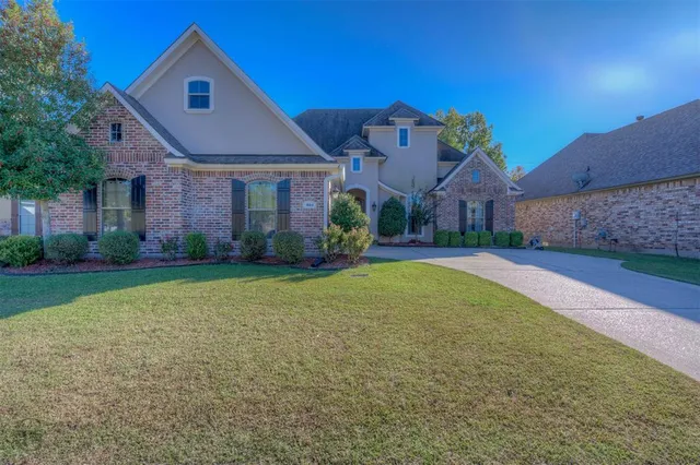 a front view of house with yard and green space