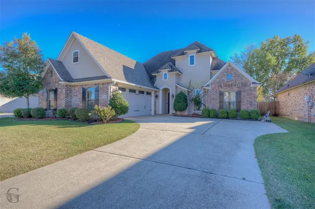 a front view of house with yard and green space