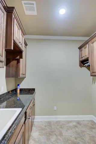 a kitchen with stainless steel appliances granite countertop a sink and a stove