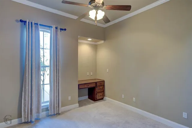 an empty room with closet and windows