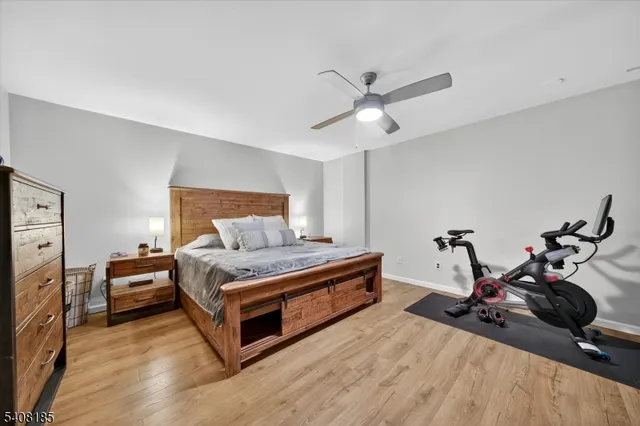 a living room with a bed furniture and a wooden floor