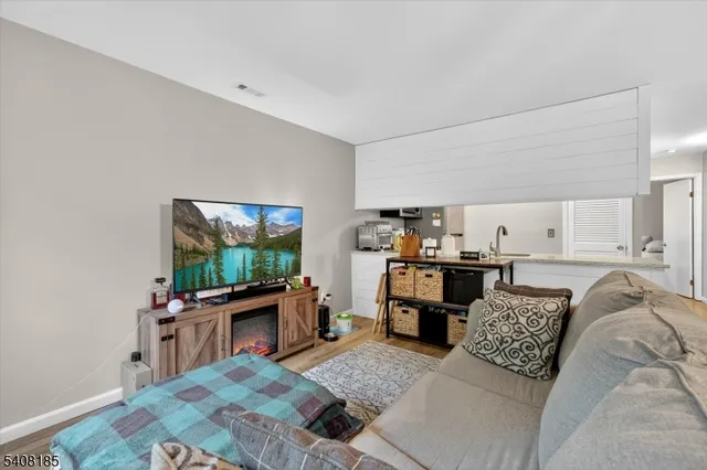 a bed room with furniture and a flat screen tv