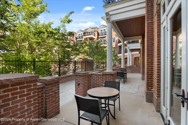 a backyard of a house with barbeque oven table and chairs
