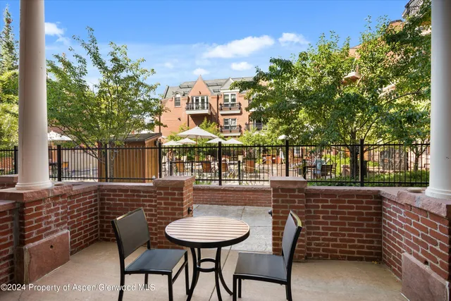 a view of a chairs and table in the patio