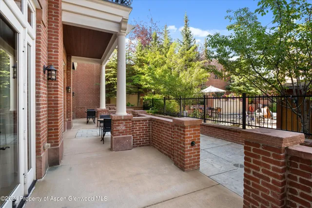a view of a porch with wooden floor and fence