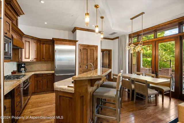 a kitchen with counter top space cabinets and wooden floor