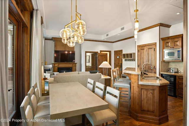 a living room with fireplace furniture and a chandelier