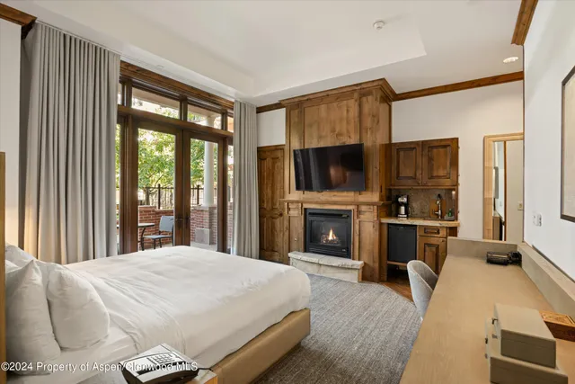 a spacious bedroom with a large bed and a fireplace