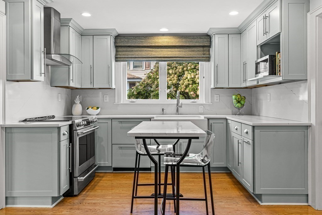 401 Weston Road Wellesley, MA 02482 - Photo 6 of 23 a kitchen with stainless steel appliances granite countertop a stove a sink and a refrigerator