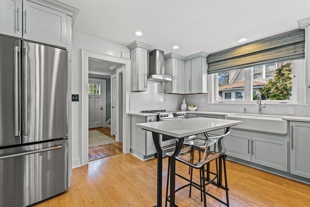 401 Weston Road Wellesley, MA 02482 - Photo 8 of 23 a kitchen with stainless steel appliances granite countertop a refrigerator a sink a stove and white cabinets with wooden floor
