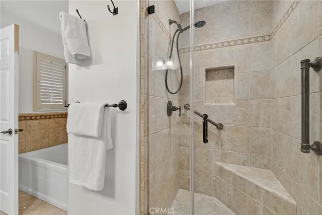 a bedroom with a bed and a lamp on dresser