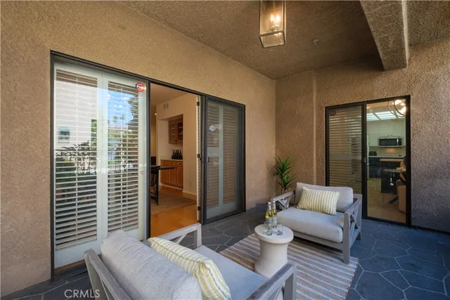 a living room with furniture and a floor to ceiling window