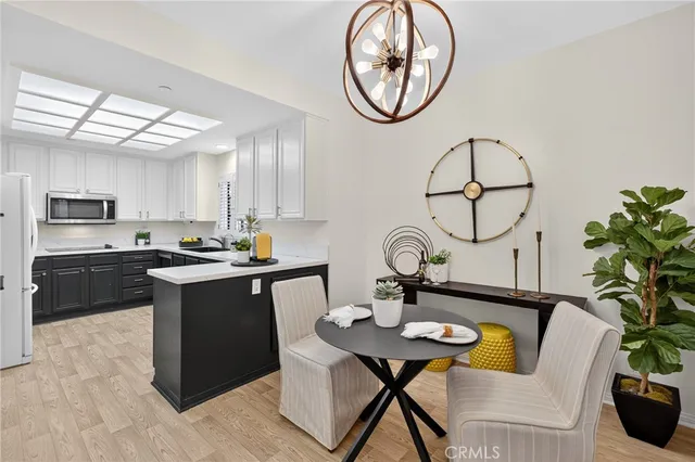a living room with furniture a chandelier and a stove