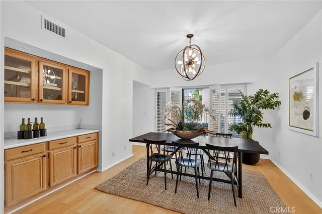 a spacious bedroom with a bed a couch and a potted plant