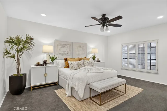 a bathroom with a granite countertop sink a mirror and shower