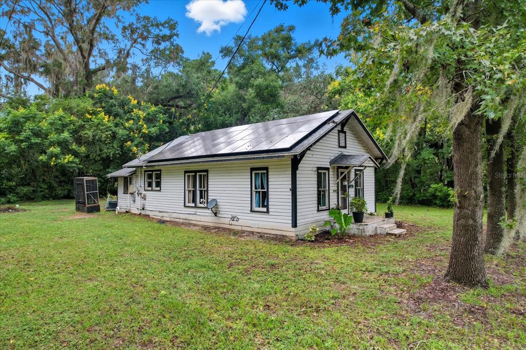 a front view of house with yard and green space