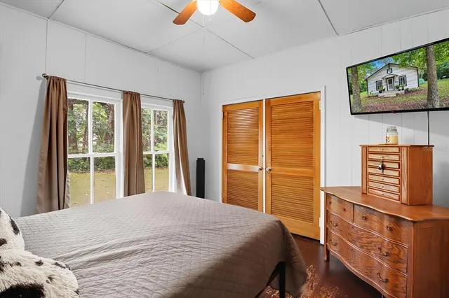 a bedroom with a bed and a window