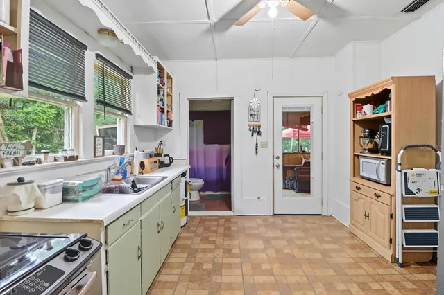 a kitchen with stainless steel appliances granite countertop a refrigerator and a stove