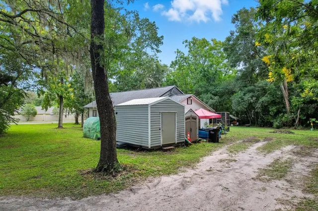 an aerial view of a house with a yard basket ball court and outdoor seating
