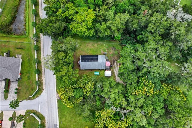 an aerial view of a house with a yard