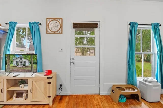 a living room with a bed and a window