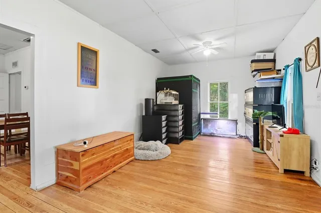 a living room with furniture gym equipment and a flat screen tv