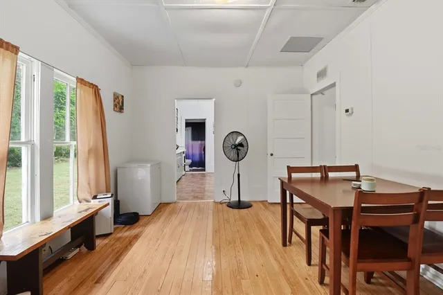 a view of a room with furniture and wooden floor