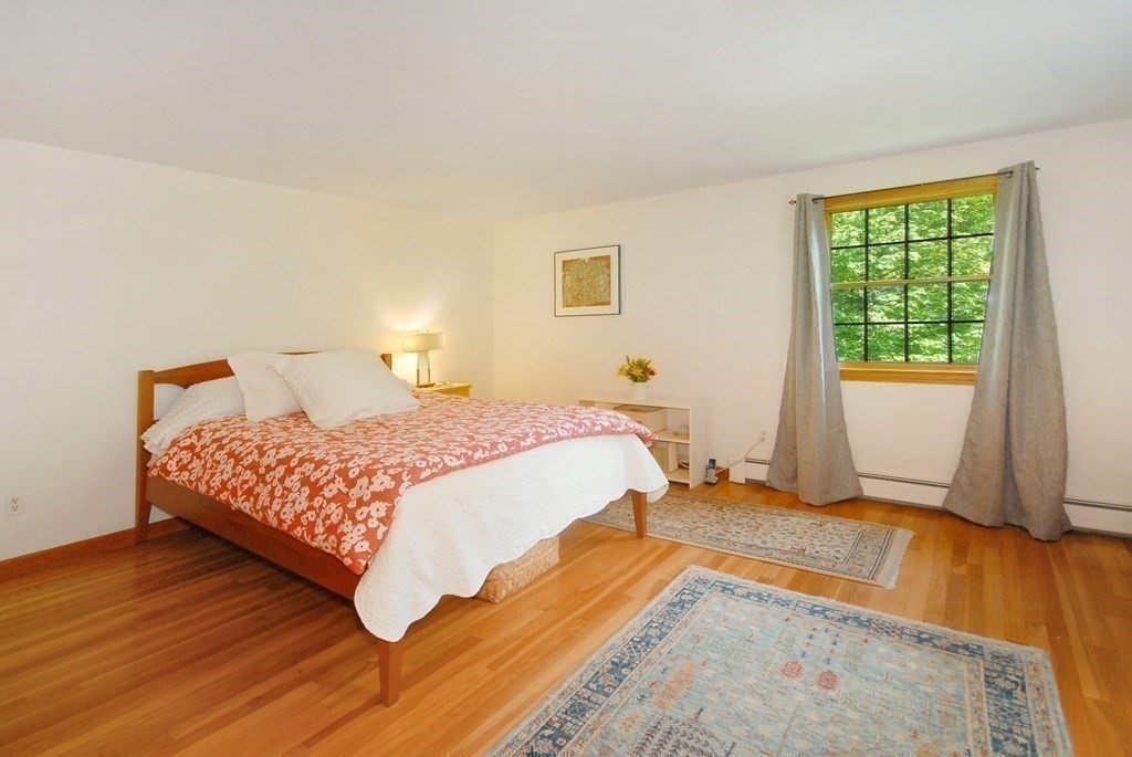 4 Farrar Road Lincoln, MA 01773 - Photo 18 of 32 a bedroom with a bed and wooden floor