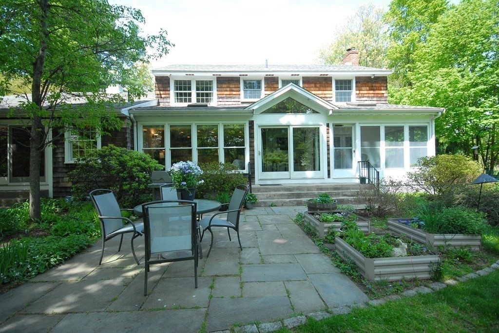 4 Farrar Road Lincoln, MA 01773 - Photo 2 of 32 a front view of a house with garden and patio