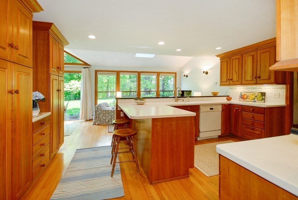 4 Farrar Road Lincoln, MA 01773 - Photo 4 of 32 a kitchen with stainless steel appliances granite countertop a table chairs sink and cabinets