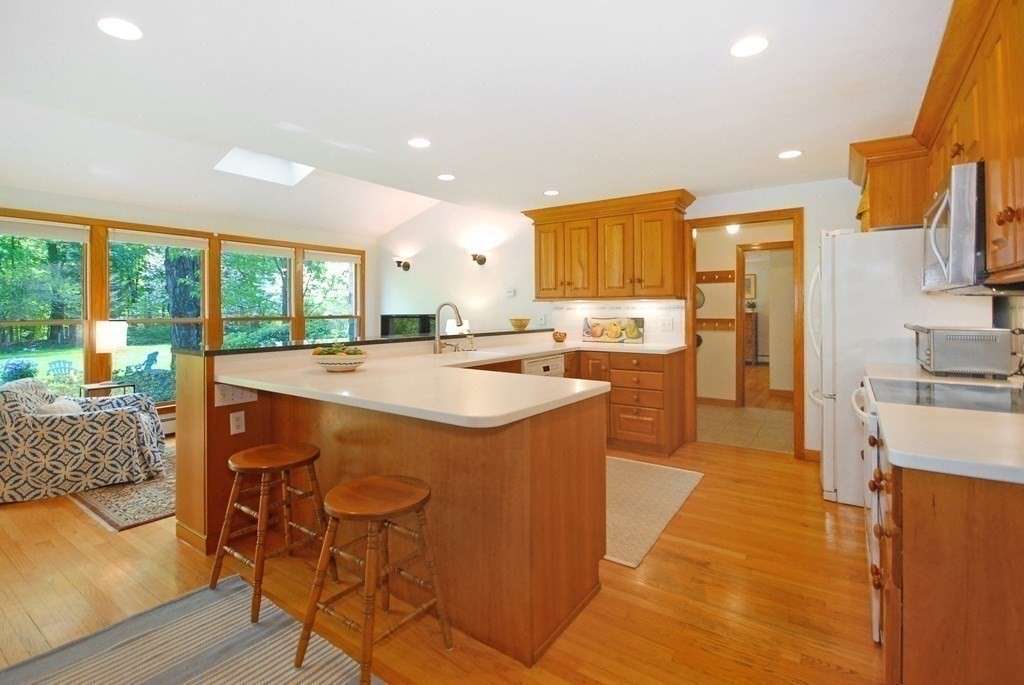 4 Farrar Road Lincoln, MA 01773 - Photo 5 of 32 a kitchen with stainless steel appliances granite countertop a sink and a refrigerator